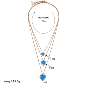 Detailed view of layered rose gold necklaces with three blue heart pendants and sizing metrics