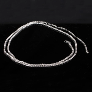 Elegant silver double-row rhinestone body chain with adjustable lobster clasp on black mirror
