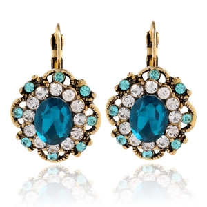 Detailed close-up of vintage bronze alloy leverback earrings with dark blue crystal and rhinestones