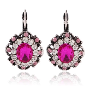 Detailed macro view of vintage flower leverback earrings with pink crystal and silver finish