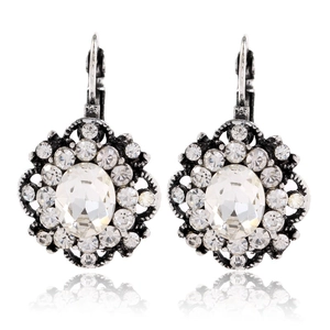Detail of silver floral drop earrings with clear oval crystals and micro-pavé rhinestones