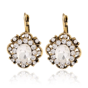 Macro detail of vintage lever-back earrings with large oval crystal and floral metalwork