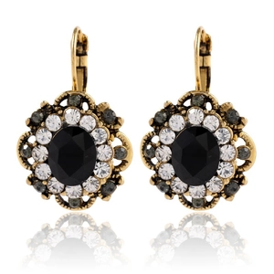 Detail of vintage teardrop earrings with black faceted gemstone and crystal halo