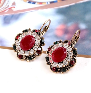 Detail view of vintage leverback earrings with oval red crystal and colorful rhinestones