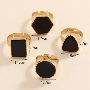 Detailed view of 4-piece vintage geometric gold alloy rings with turquoise black stones