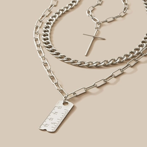 Three-layer silver chain necklace set featuring cross and ruler pendants in minimalist style