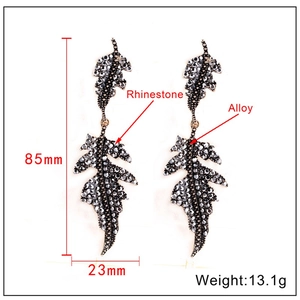 Detail view of leaf earrings with grey rhinestones, dimensions 85mm by 23mm