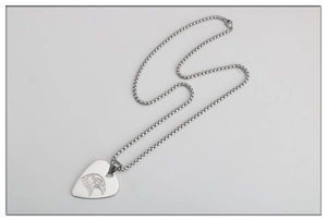 Detail showing an eagle engraved stainless steel guitar pick pendant with box chain