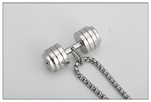 Macro detail of polished stainless steel dumbbell pendant with textured grip on box chain