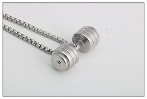 Detailed macro view of polished silver dumbbell pendant on a classic box chain