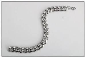 Polished stainless steel thick Cuban link chain bracelet for men and women on white background