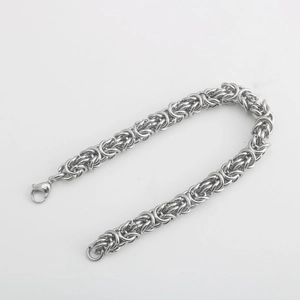 Detailed macro view of silver Byzantine chain bracelet with a sturdy lobster clasp closure