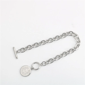 Close-up of Saint Benedict amulet on silver stainless steel chain with T-bar toggle clasp