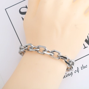 Close-up of a silver chunky chain link bracelet worn on a wrist for men and women
