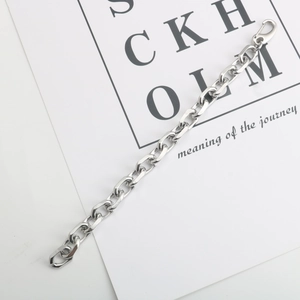 Detailed view of silver thick link chain bracelet with lobster clasp on white background