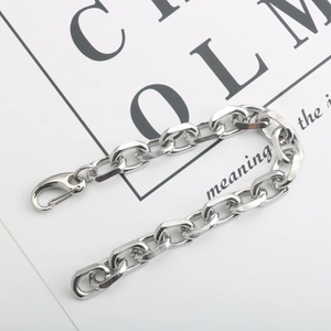 Detailed macro view of heavy curb chain bracelet in silver steel with lobster clasp