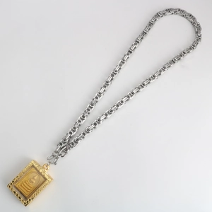 Silver Byzantine chain necklace with a gold Thai Buddha amulet pendant in a rectangular case