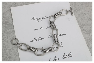 Handmade stainless steel O-chain bracelet with OT buckle closure on stone texture
