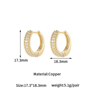 Macro detail of gold-plated hoop earrings with size dimensions and micro-pave zircons