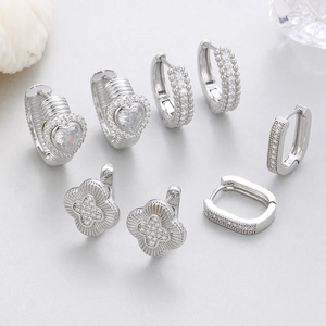 Sparkling silver stud earrings set with heart and clover designs in cubic zirconia