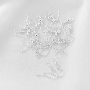 Macro view of silver earring hooks with spring and bead details for DIY jewelry making