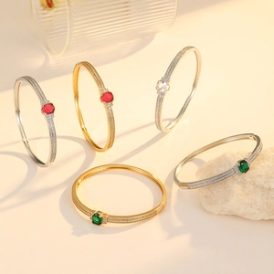 Vintage emerald zircon bangles with gold and silver finishes and pavé side stones