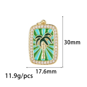 Detail view of a square gold pendant with palm tree enamel and zircon border