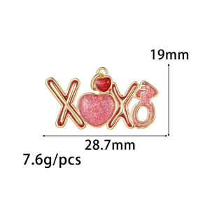 Detailed view of XOXO heart charm with red pink glitter oil drip for DIY jewelry making
