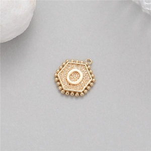 Detailed macro view of 14K gold plated hexagonal pendant featuring a 3D letter O design