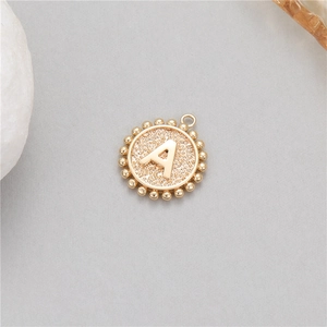 Close-up of 14K gold plated letter A pendant with decorative beaded edge for DIY jewelry