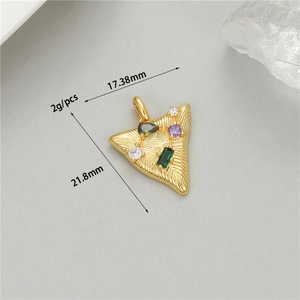 Macro view of 14K gold plated triangle pendant with radial engraving and colorful gems