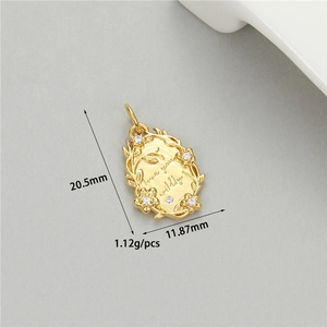Macro view of gold-plated oval pendant with Love you wildly engraving and zircon details