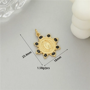 Detailed view of 14K gold plated sun pendant with religious relief and black zircon gems
