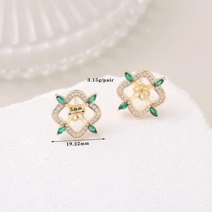 Detail view of gold clover earrings with green zircon and pavé diamonds, weighing 3.15g