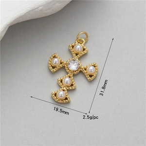 Detailed size view of a vintage gold cross pendant with pearls and zircon crystals