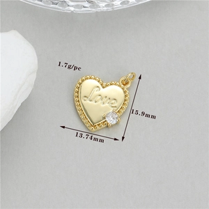 Détail d'un pendentif coeur doré avec gravure Love et une pierre de zircone brillante