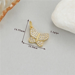 Detailed view of gold bow pendant with colorful cubic zirconia stones and size measurements