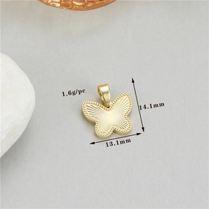 Macro shot of gold bow pendant with sunburst texture and precise 14.1x13.1mm dimensions