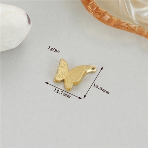 Detailed view of golden butterfly pendant with dimensions 12.7mm by 13.3mm and 1g weight