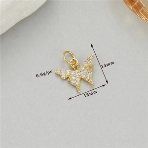 Macro detail of gold butterfly pendant with zircons showing dimensions 13mm by 14mm