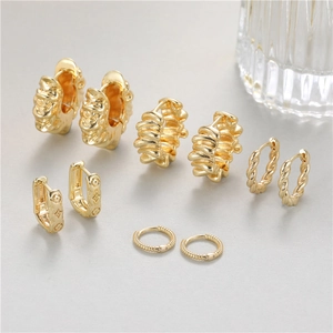 Irregular textured gold hoop earrings set with minimalist french vintage luxury design