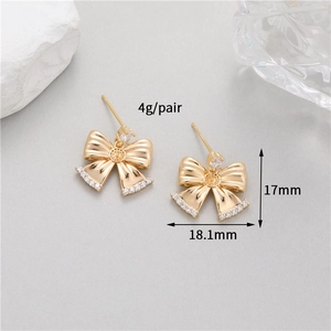 Detail view of gold bow earrings with micro-inlaid cubic zirconia and size 18.1mm x 17mm