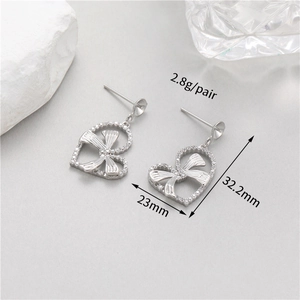 Detail view of heart bow earrings with silver zircon stones showing 32.2mm length