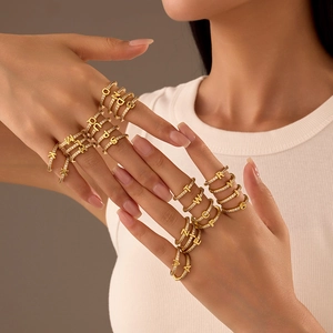 Adjustable gold letter ring set with zircon pavé, featuring A-Z alphabet designs