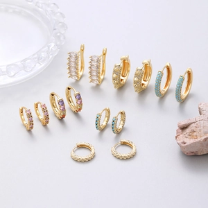 Elegant gold hoop earrings set with colorful zircons and turquoise stones in a luxury layout