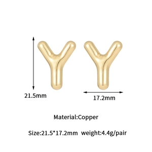 Macro detail of gold bubble letter Y earring showing size dimensions and copper material
