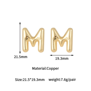 Detail of gold letter M stud earrings in polished brass with size and weight specs
