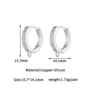 Macro view of zircon-studded 14k gold-plated hoops with pendant loop measuring 15.7mm