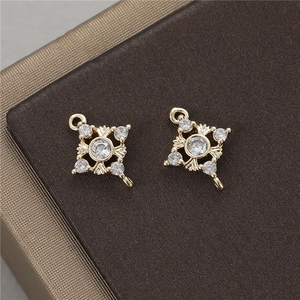 Detail of square cross pendant connectors in gold with zircon stones for jewelry making