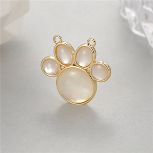 Detailed view of cat paw mother of pearl pendant with gold plating and double rings